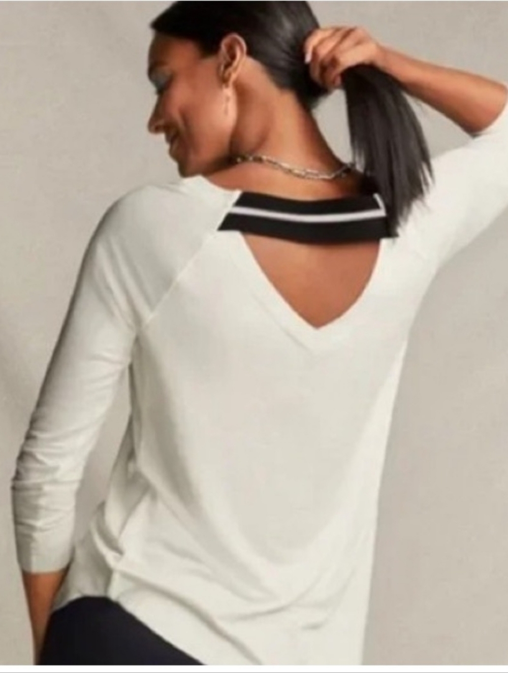 Cabi Women’s White V-Neck Back Cutout Top with Black Accent. Size Meduim